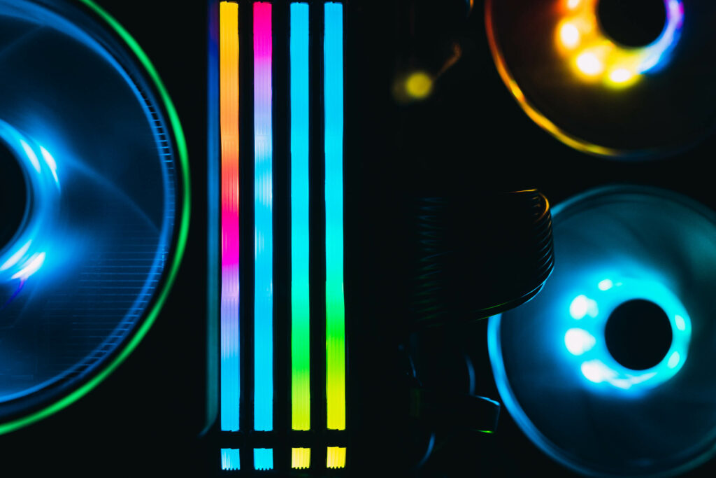 Computer parts with colorful LEDs on the ram and fans.