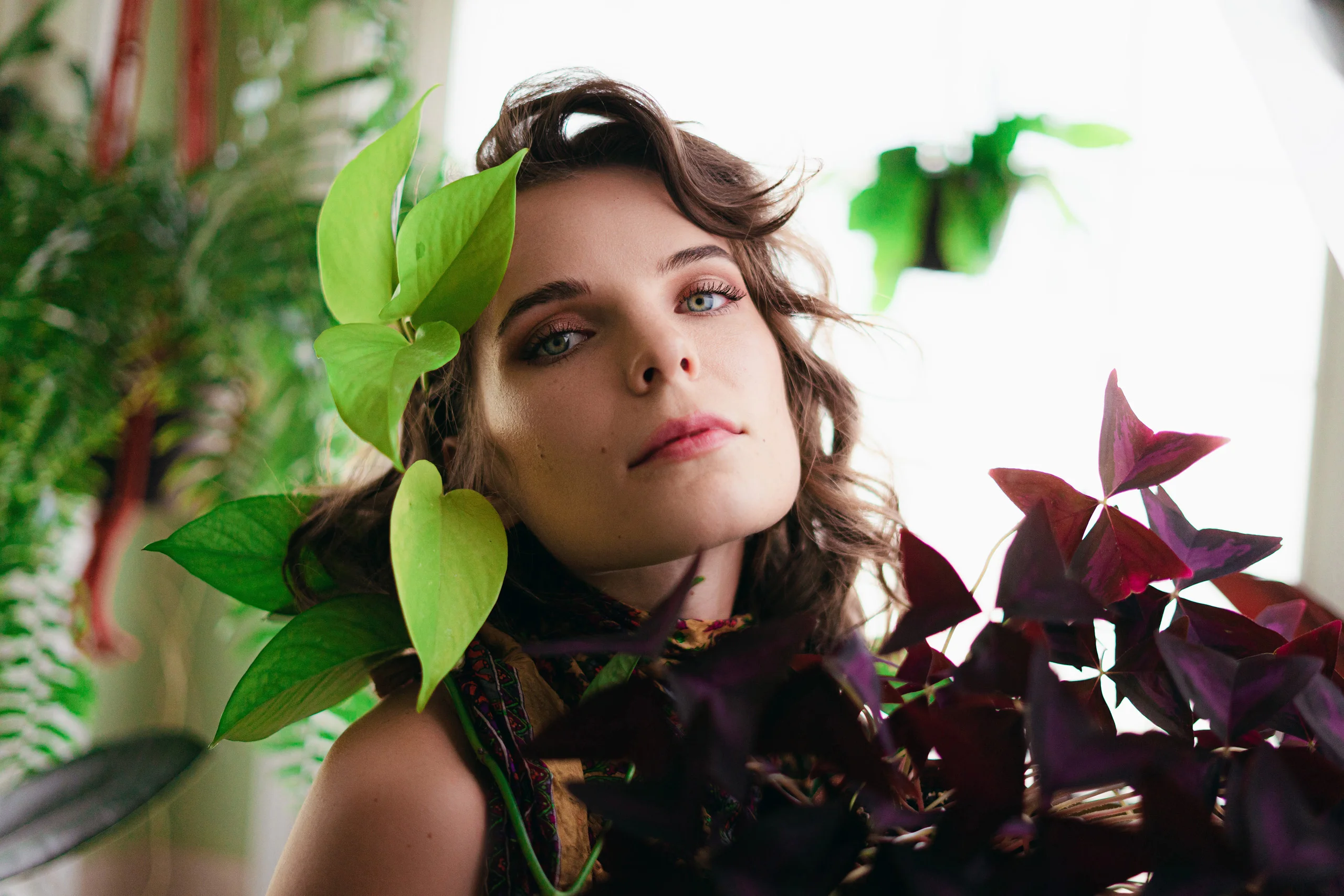 Editing process of a photo of a woman surrounded by plants.