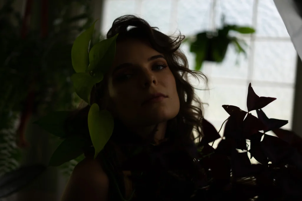 Editing process of a photo of a woman surrounded by plants.